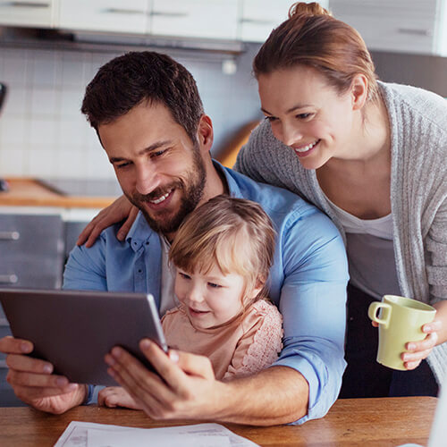 Smiling family using tablet