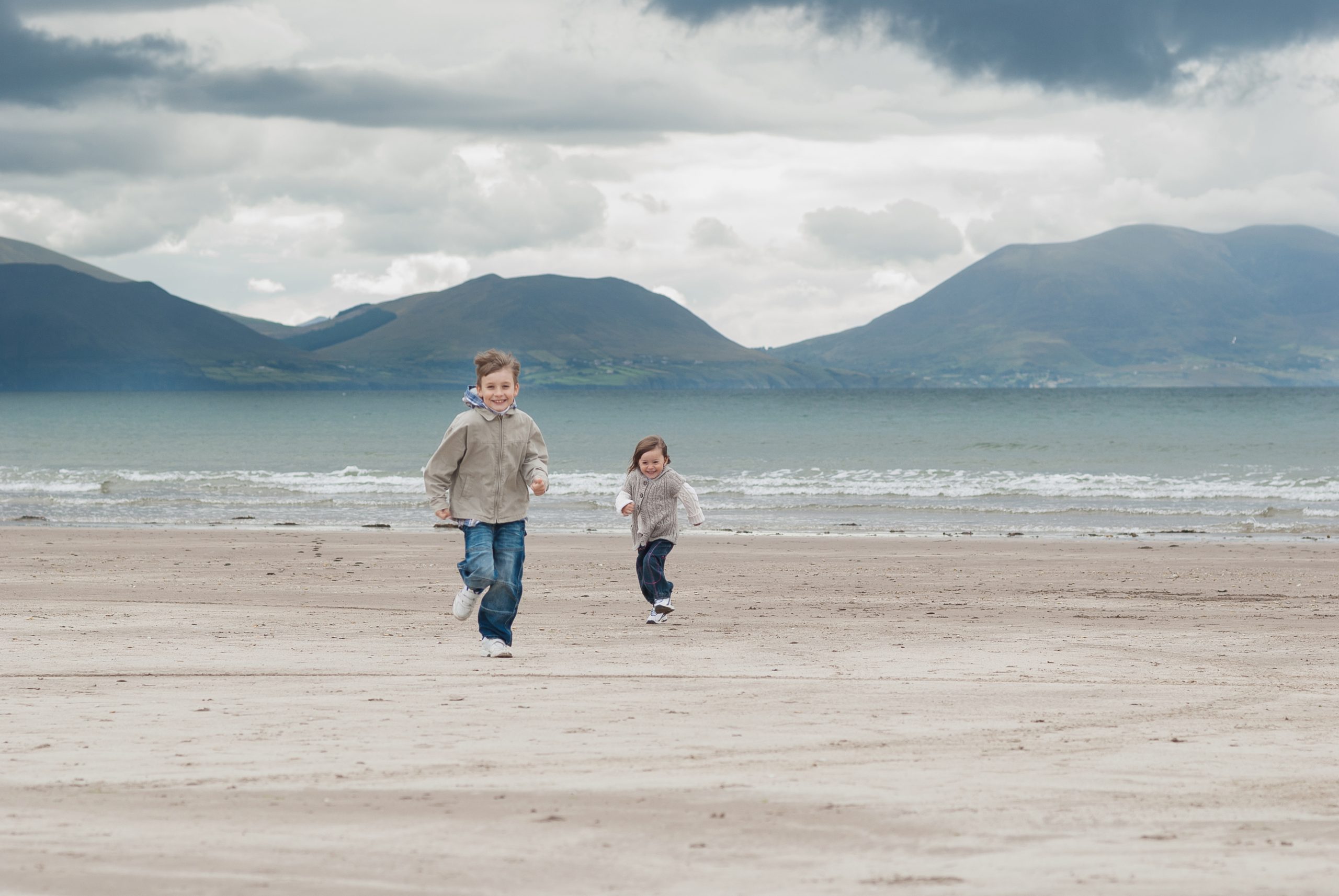 Kids on beach running towards camera